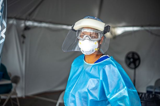 A member with the Florida Department of Health tests residents for COVID-19 at one of Lake County's testing sites in Tavares, Florida.