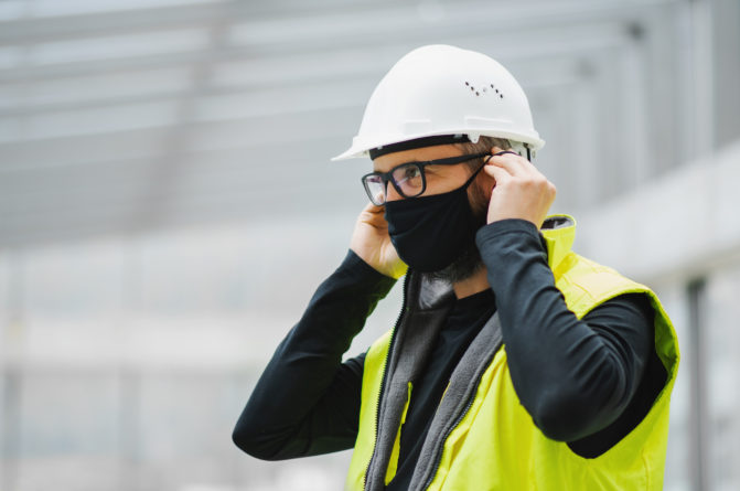 Side view portrait of worker with face mask at the airport.